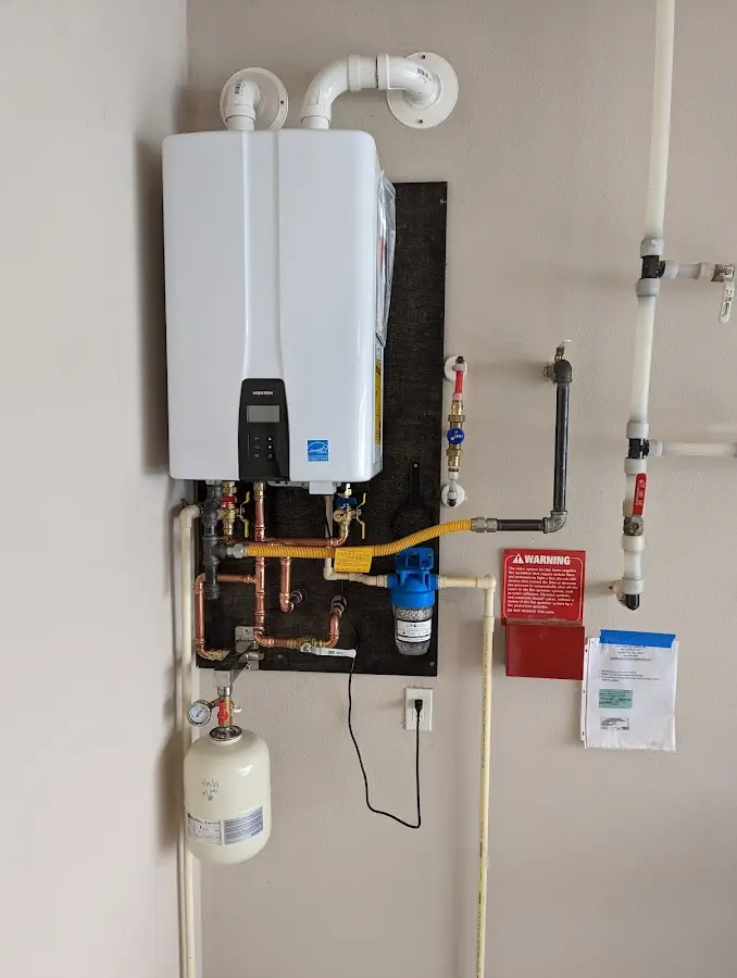 Professional plumber installing copper piping in a Lexington Park home